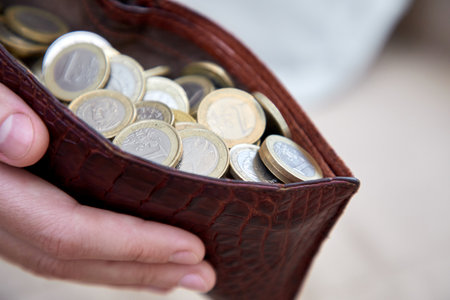 man hand putting money closeupの写真素材