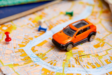 travel concept - small toy car on the mapの写真素材