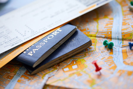 pins marking travel itinerary points on map and passportの写真素材
