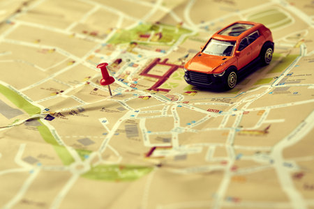 travel concept - small toy car on the mapの写真素材