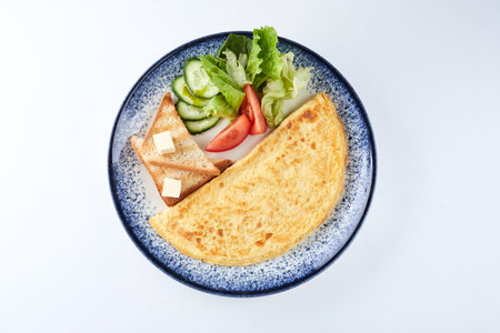 omelet with fresh vegetables and toastsの写真素材