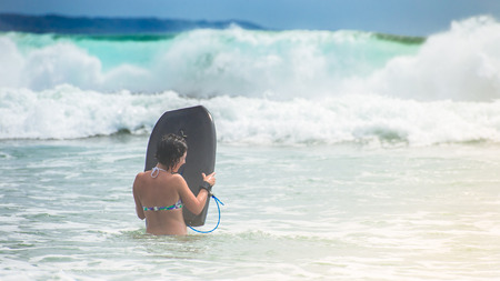 Charming girl learns to ride the surfの写真素材