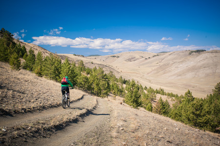 The girl on  bicycle down a steep hillの写真素材