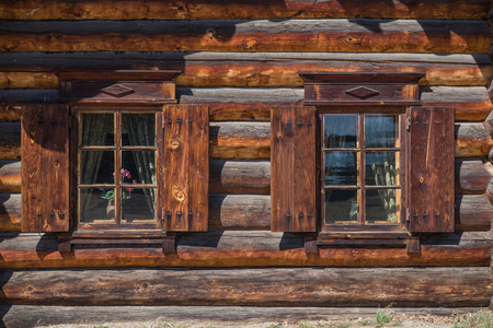 Windows in a traditional wooden houseの写真素材