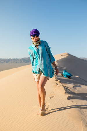 Beautiful young girl walking on the desert Gobiの写真素材
