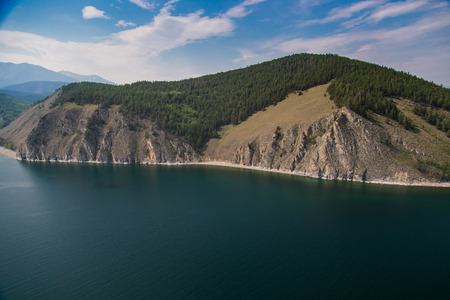 Wild coast with mountains and forest from the air. Siberia.の写真素材