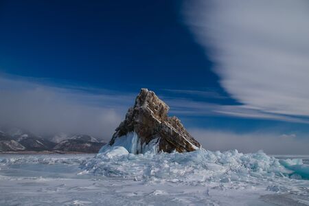 The rocky island in the ice of Baikal lakeの写真素材