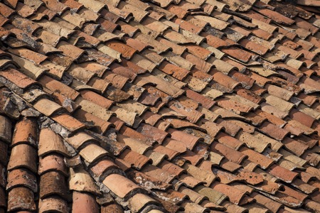 Old clay tiles on the roof of a house in Bulgaria. Backgroundの写真素材