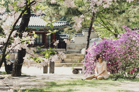 Beautiful girl and flowering rhododendronの写真素材