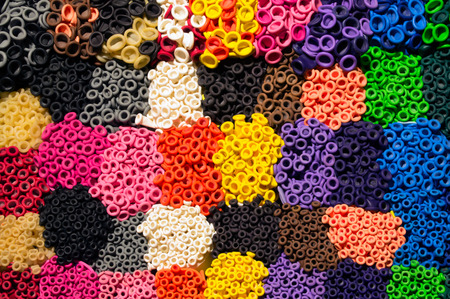 Pattern of colorful latex balloon nozzles organized by colors