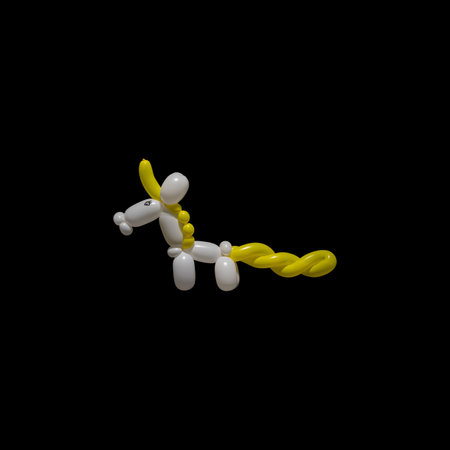 A cute white unicorn balloon animal with a yellow mane, tail and horn like a clown or entertainer might make at a birthday party or event using balloon twisting with latex balloons.の写真素材
