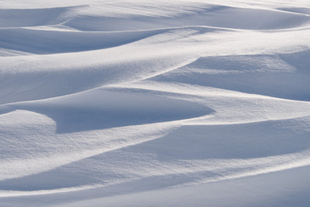 Snow drifts in the sunlight.の写真素材