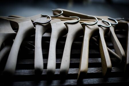 A row of wooden coathangers without clothesの写真素材