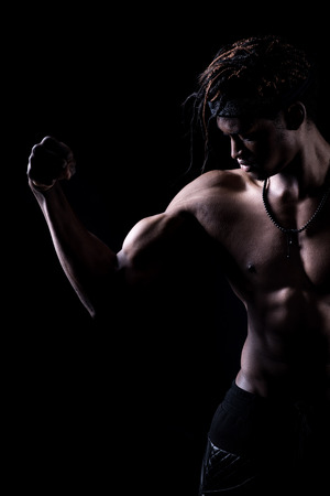 Muscular man on a black backgroundの写真素材