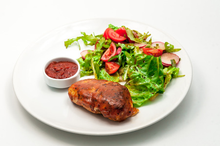 Grilled chicken breast with fresh vegetable saladの写真素材