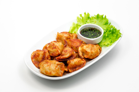Fried dumplings with soy sauce on white backgroundの写真素材