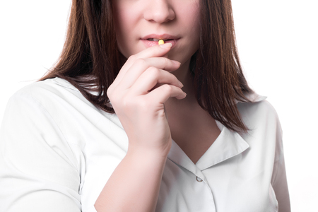 Take a pil. Women are taking and eating medicines for help sickの写真素材