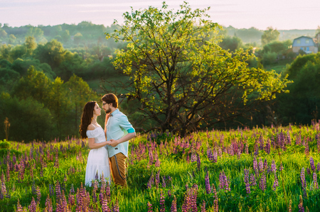 a couple in love in a beautiful landscape standing closer to each other, hand in hand, eyeball-to-eyeballの写真素材