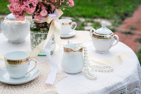 Nice table served for a tea ceremony for the two, pearl beads hanging out of the cup. Picnicの写真素材