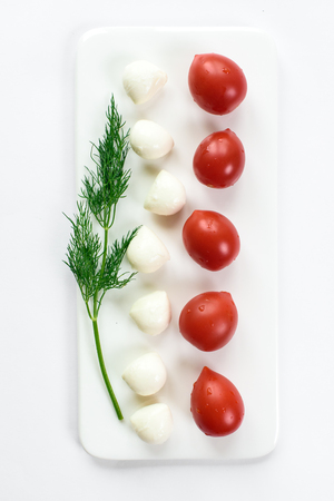 Top view of a tomato and cheese duet isolated in white, copy space. Concept of cookingの写真素材