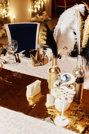 Tables set for an event party or wedding reception. luxury elegant table setting dinner in a restaurant. Black and gold glasses and dishes.の写真素材