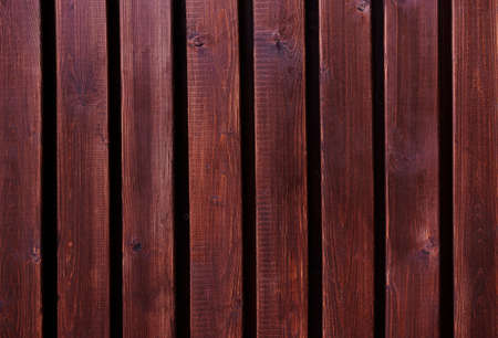 Wooden fence texture. Old brown and wine wooden wall, detailed background photo texture. Wood plank fence whith chamfer close up.の写真素材