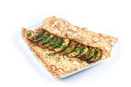 Baked potatoes on a pita bread on a white plate in a restaurant. Stay home and cook concept. Country style food. Close up view. Isolated on white backgroundの写真素材
