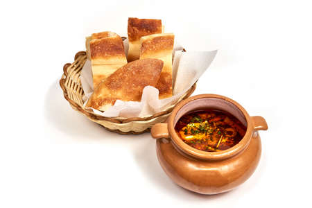 Dish of russian hodgepodge soup served with a slice of bread. Serving dishes in a cafe, restaurant, for a menu. Isolated on white backgroundの写真素材