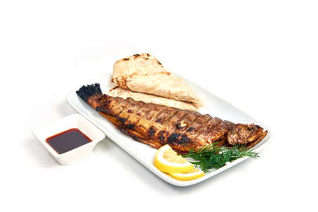 Grilled trout with vegetables on a plate isolated on white. Serving dishes in a cafe, restaurant, for a menu.の写真素材