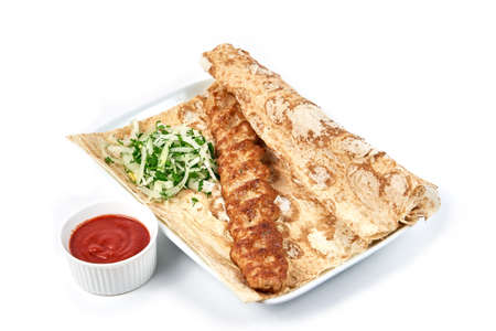 Minced chicken skewers. Lula kebab with white onion and pita bread, traditional Caucasian dish. Serving dishes in a cafe, restaurant, for a menu. Isolated on white backgroundの写真素材