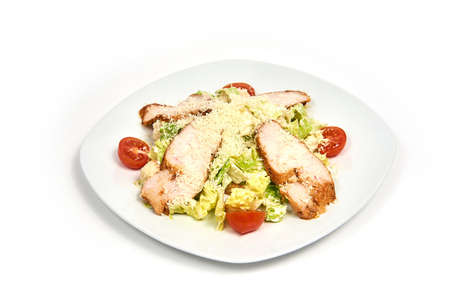 Plate of chicken caesar salad isolated on white background.の写真素材