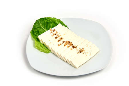 Cheese on a plate on white background. Serving dishes in a cafe, restaurant, for a menu.の写真素材