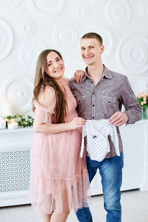 Young couple expecting baby standing together.の写真素材