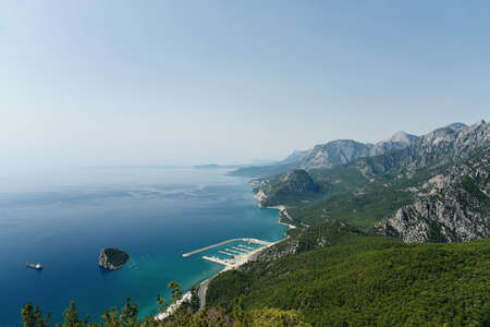 View of landscape with boats and sea in marina bay from Tunektepe Teleferik on the coast of Antalya, Turkey. Beautiful sunny aerial view of Turkish marine landscape. Charming nature background.の写真素材