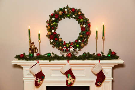 Christmas wreath above classical fireplace. Xmas scene. Place for text. Suitable for Christmas background.の写真素材