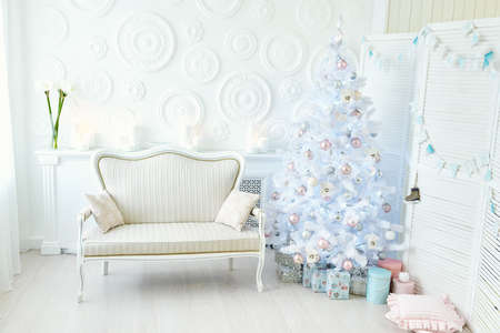 Interior living room with a Christmas tree with gift boxes and decorations.の写真素材