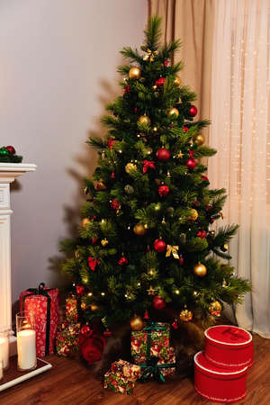 Beautifully decorated Christmas tree with many presents under it.の写真素材
