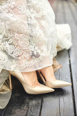 Bride's shoes and bride's dress. Wedding concept.の写真素材