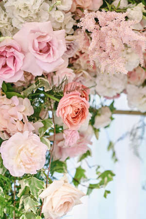 Lush floral arrangement of white and pink fresh flowers. Luxury wedding table decorations. Vertical photographyの写真素材