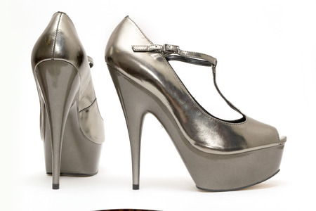 A pair of Womens gold high heels on white backgroundの写真素材