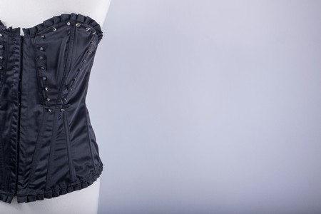 A Tailors Mannequin dressed in a Black Corset with Spikesの写真素材