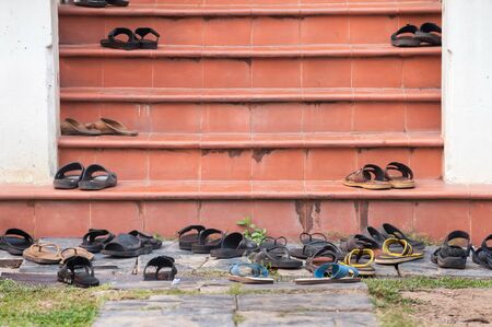 Shoes left on temple steps, Thailandの写真素材