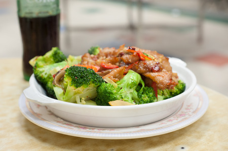 Stir-fried pork and broccoli dish served at a Hong Kong Cooked Food Centreの写真素材