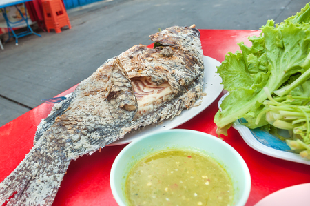 Thai grilled fish served at a street-side restaurant in Bangkok, Thailandの写真素材