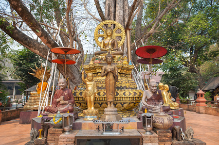 Small chedi surrounded by Buddha status at Wat Jed Yod, Chiang Mai, Thailandの写真素材