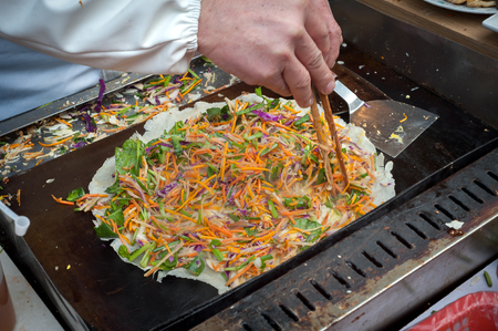 Chinese Jianbing pancake being prepared at a Shanghai street marketの写真素材