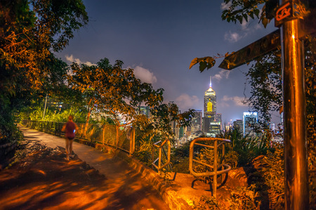 A woman runs along the Bowen Road fitness trail at night, Wan Chai, Hong Kongの写真素材