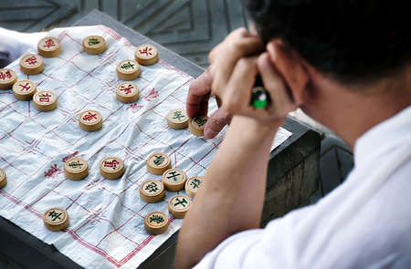 Man playing the traditional Chinese game of xiangqi, also known as Chinese chess, in Guilin, China....