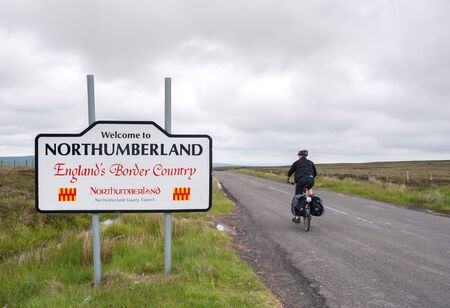 Male cyclist entering Northumberland on the Coast to Coast trail, UKのeditorial素材