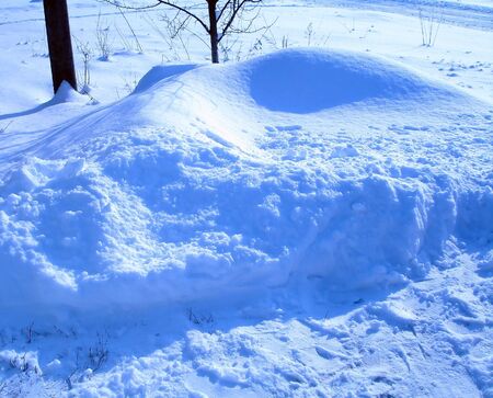 snowdrift behind a road at frosty sunshine dayの写真素材